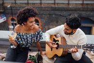 Man and Woman Holding Acoustic Guitars