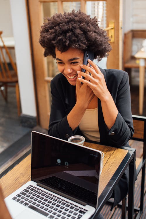 Woman in Black Blazer Happy Talking on the Phone 