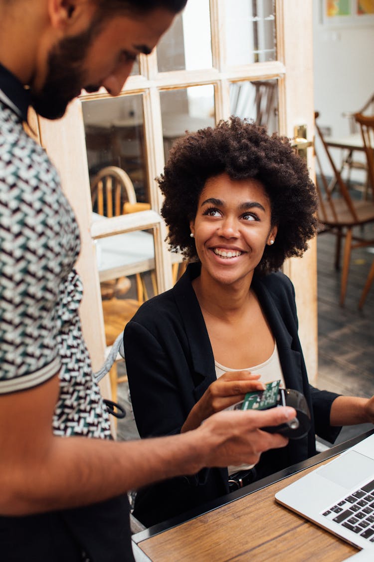  Smiling Woman Paying The Waiter Contactless With A Bank Card