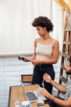 A man and woman engaged in a business transaction with a payment terminal.