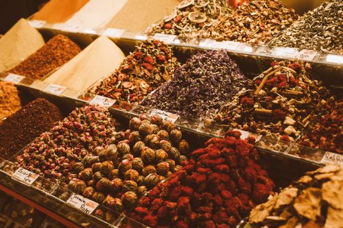 Free A detailed display of colorful spices, teas, and herbs at a market stall. Stock Photo