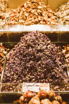 Vibrant dried herbs and spices stacked in a market stall, showcasing rich colors and aromas.
