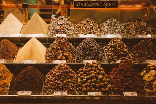 Colorful assortment of traditional spices on display in a vibrant market setting.