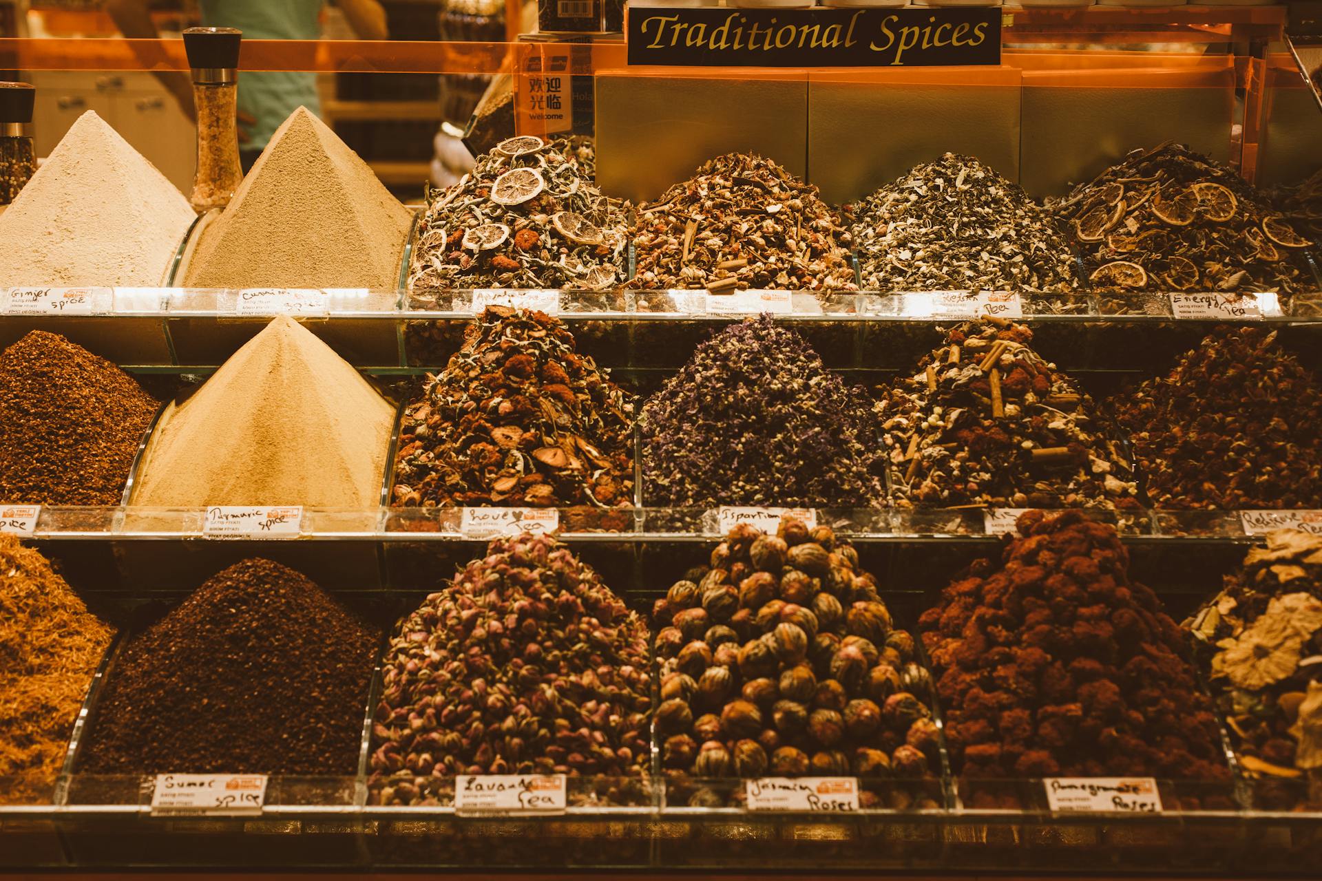 Colorful assortment of traditional spices on display in a vibrant market setting.