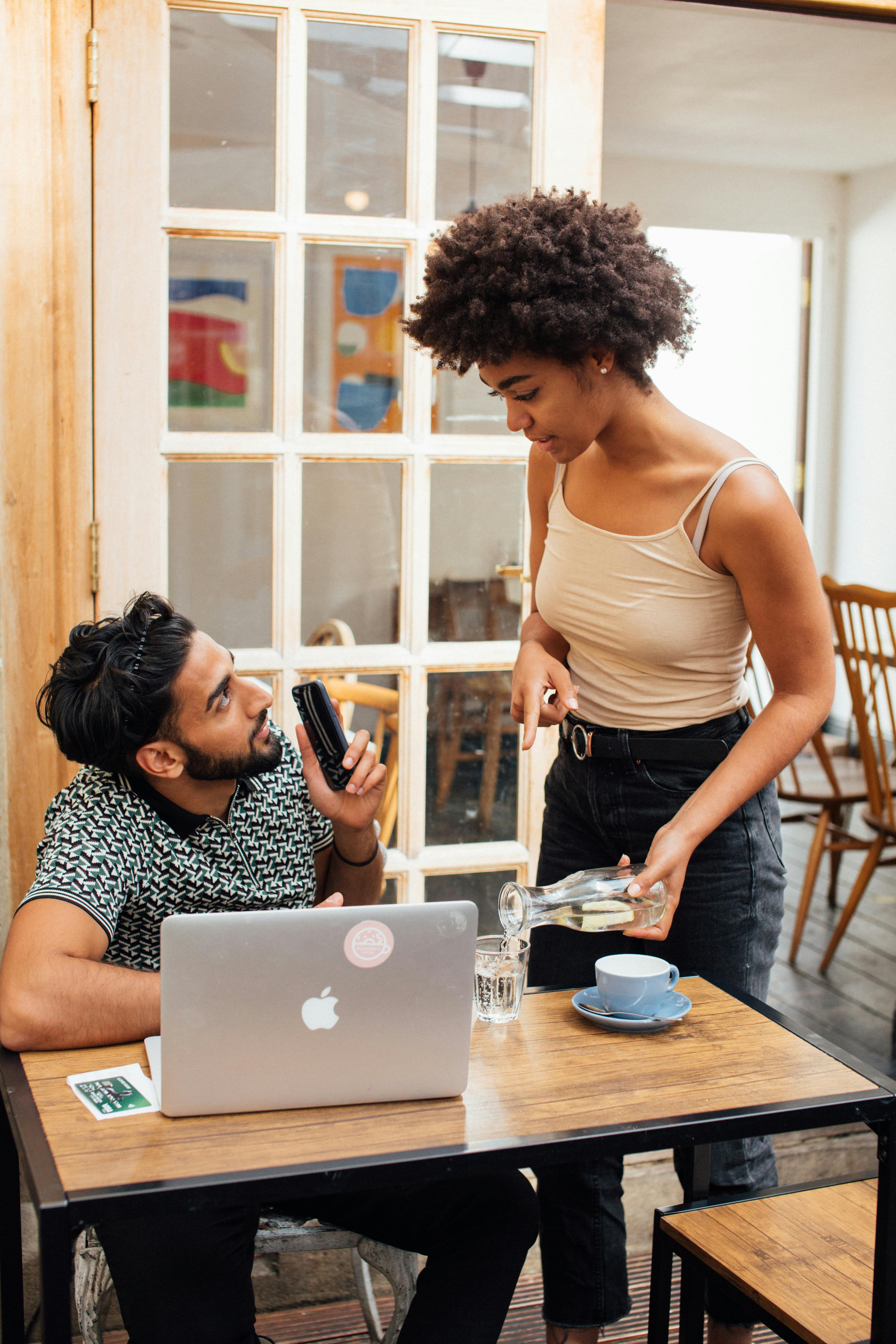 A Man and Woman Talking Inside the Coffee Shop