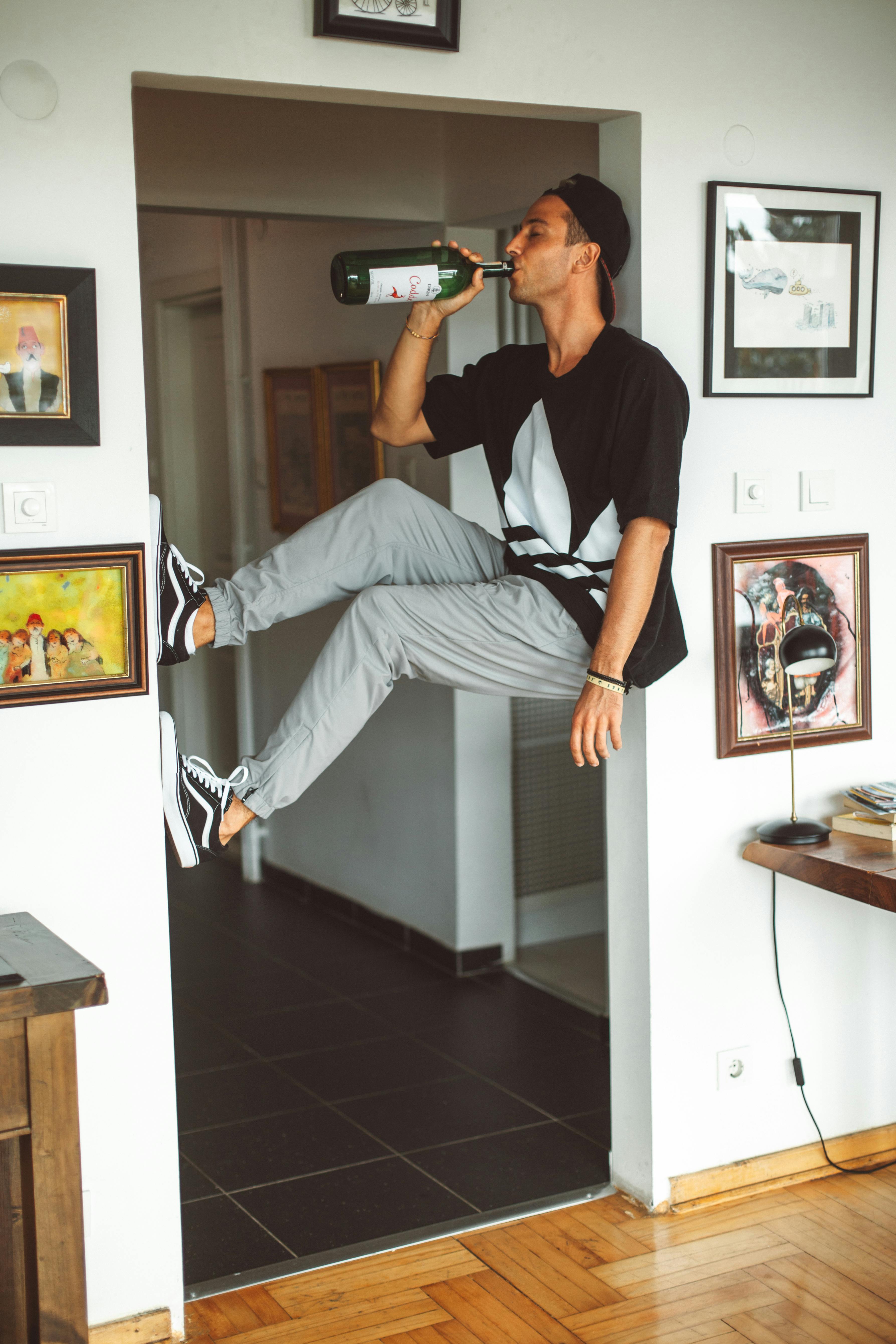 man drinking alcohol alone at home