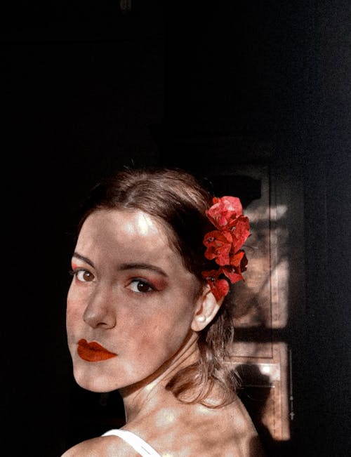 Pretty Woman with Red Flower on Her Ear