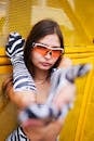 Fashionable serious woman holding hand out