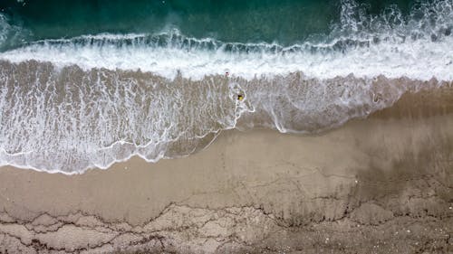 Free Aerial Photography Crashing Waves on Beach Shore Stock Photo