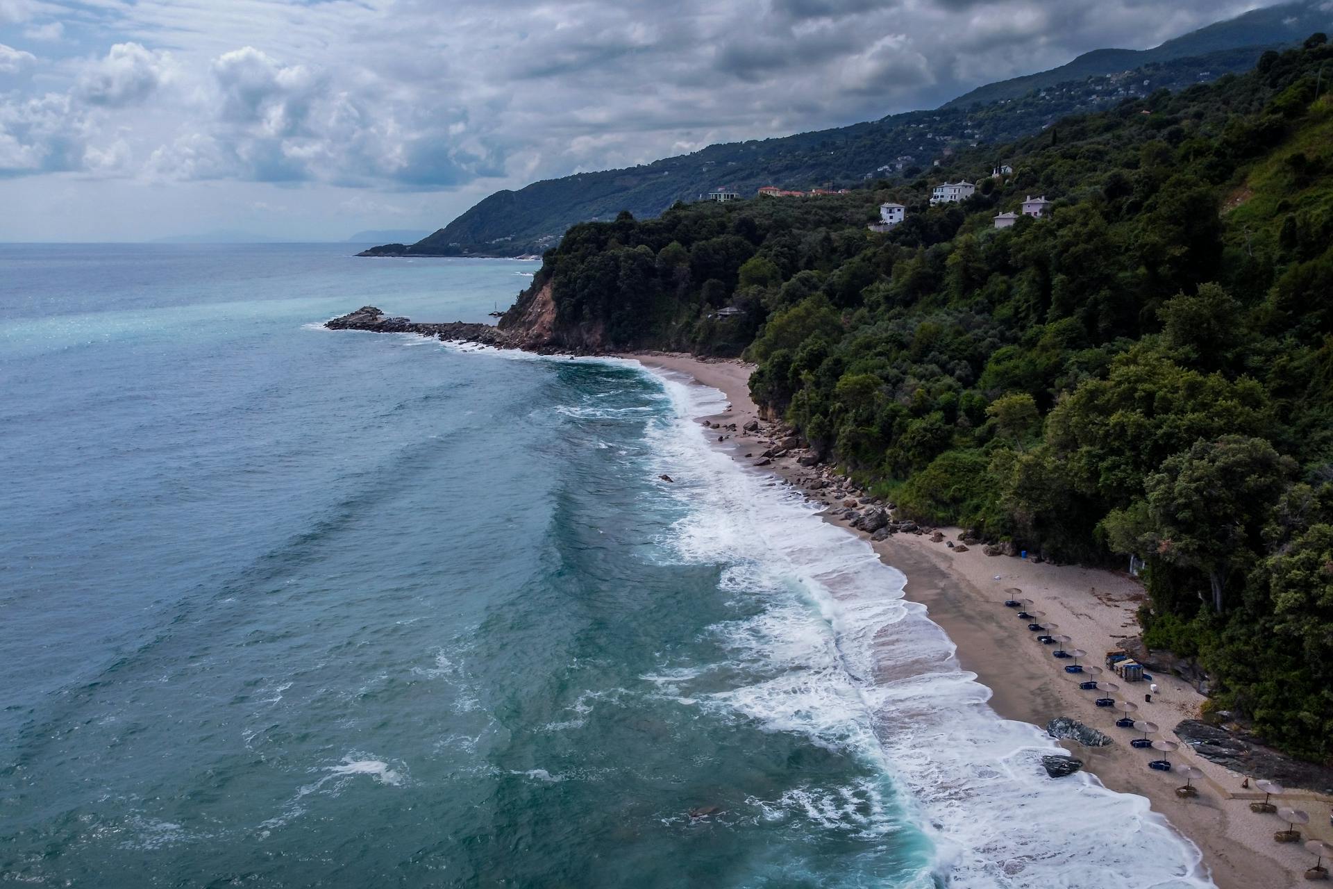 Stunning aerial view of Pelion's coastline in Greece with lush forests and blue sea.