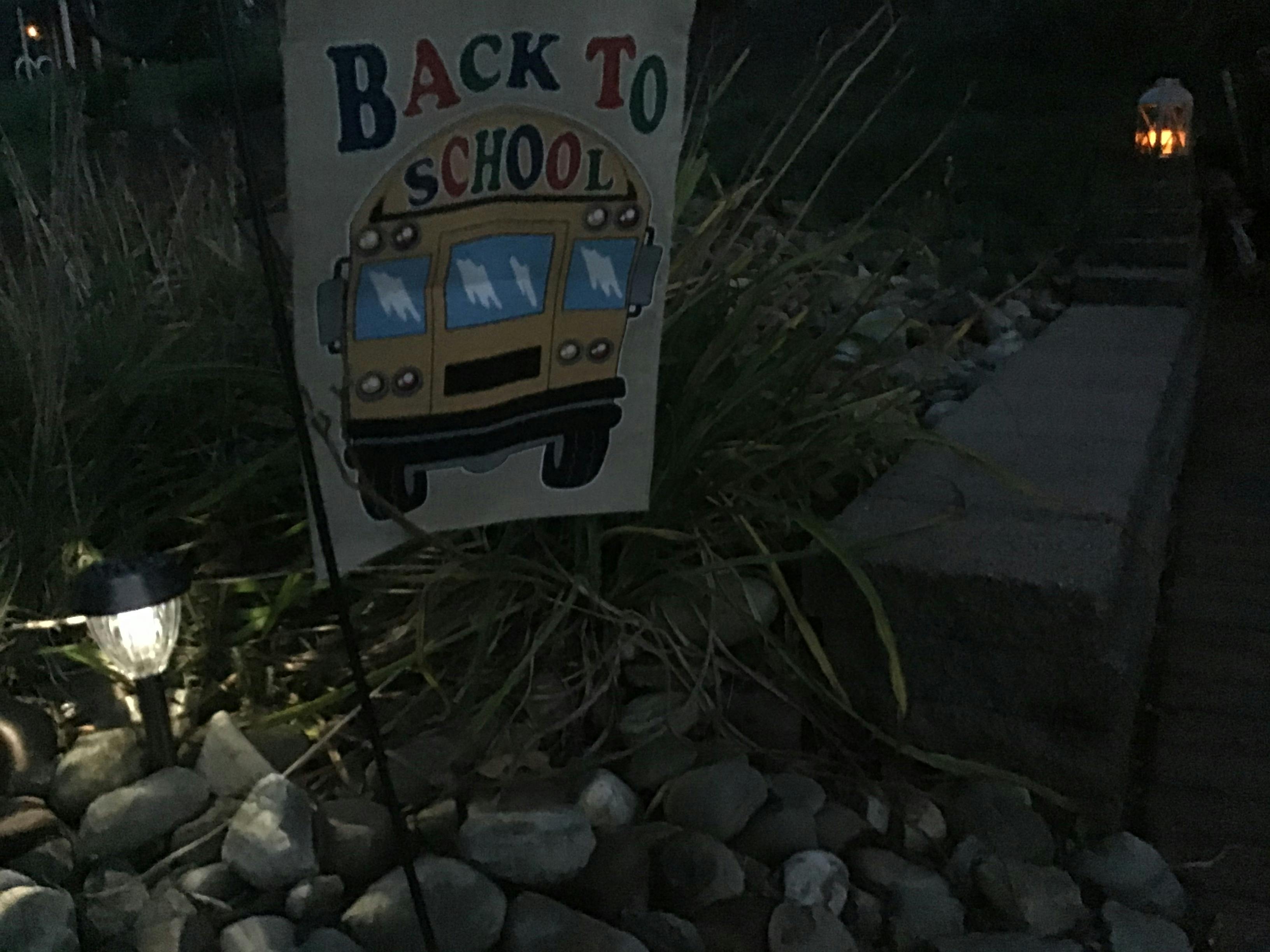 Overhead view of two yogurt bowls with fruit and nuts on a white table