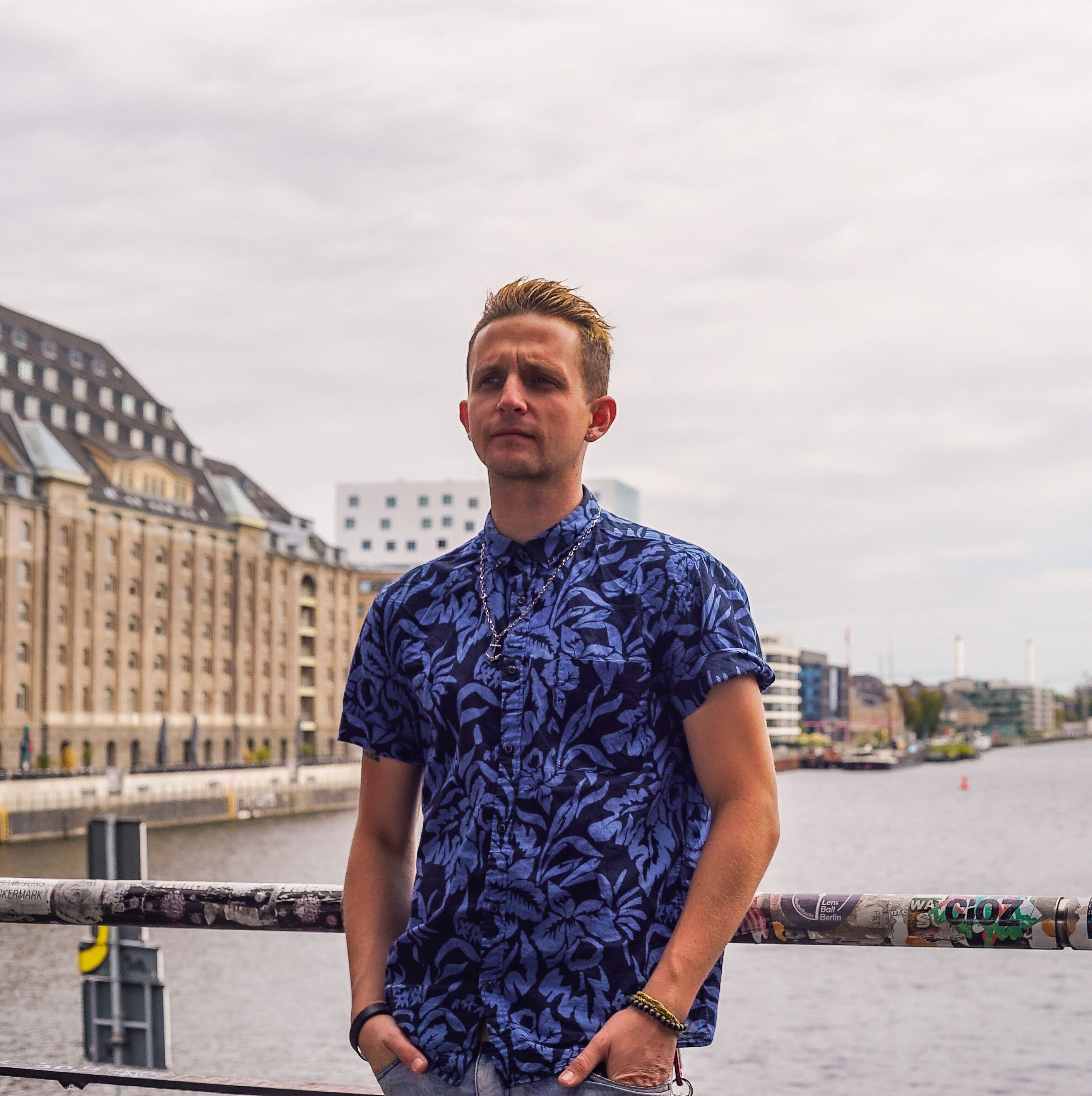 Young man on bridge over river · Free Stock Photo