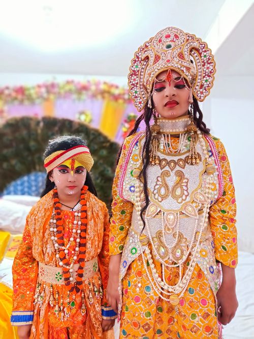 Free Two children dressed in vibrant traditional clothing for the Hindu festival of Janmashtami. Stock Photo