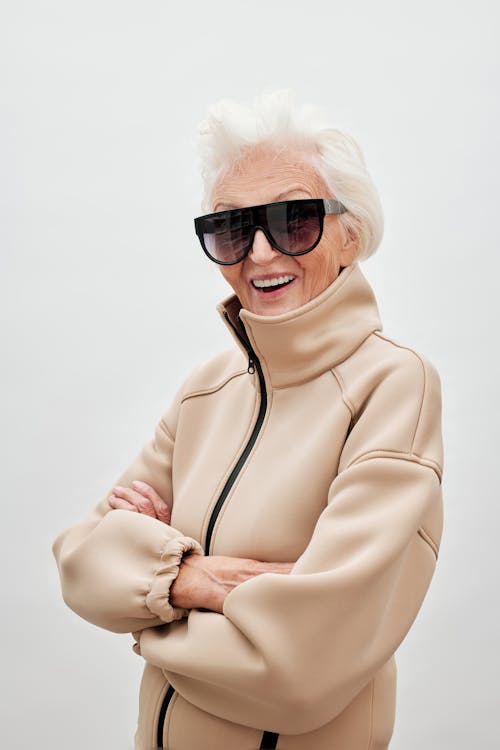 Free Woman in White Hoodie Wearing Black Sunglasses Stock Photo