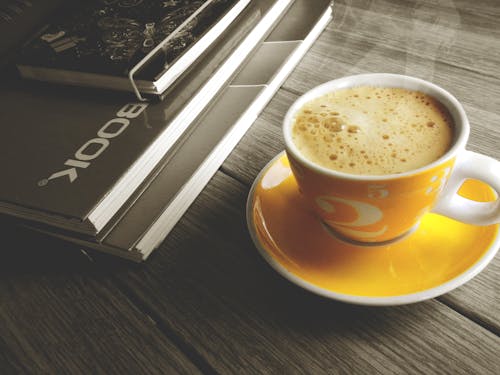 Free Orange and White Cup on Top of Saucer Filled With Coffee Stock Photo