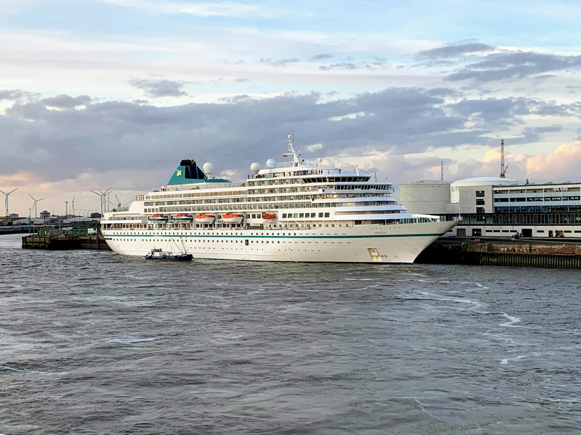 A large cruise ship at a pier in Bremerhaven, Germany, during the day.