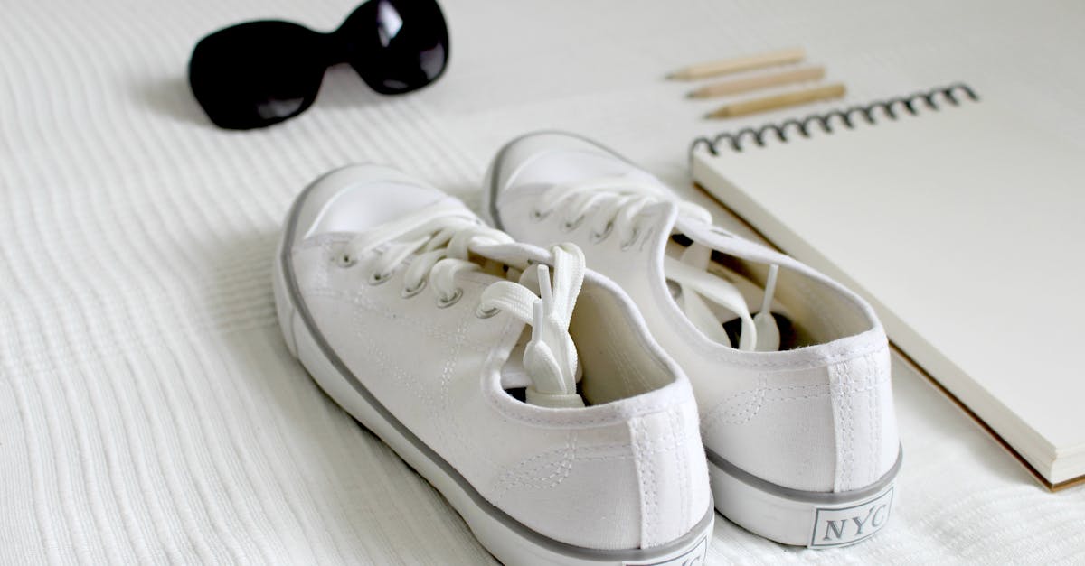 Pair Of White Nyc Low-top Sneakers Beside Notebook · Free Stock Photo