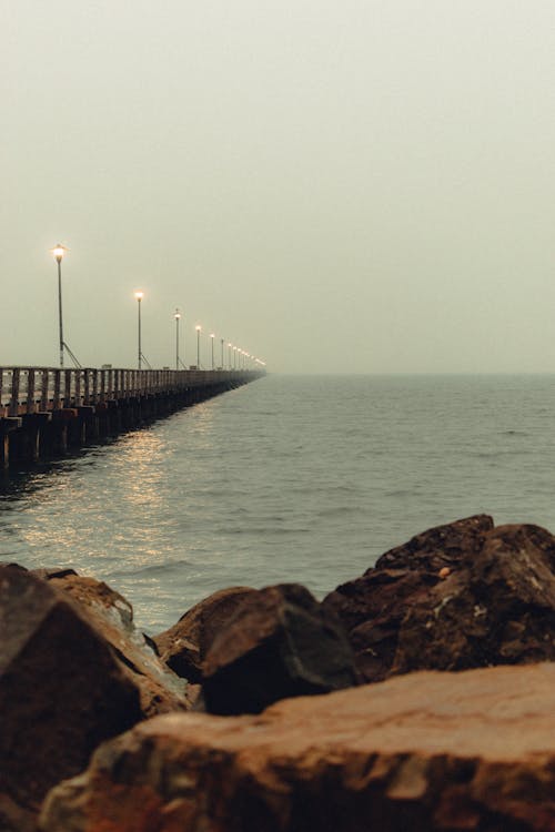 Peaceful empty pier on rocky coast