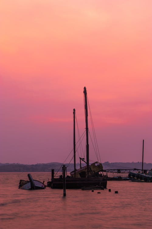 Boats floating on rippling water in picturesque sunset