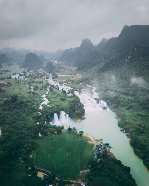Mountains and Village by the River in a Valley 