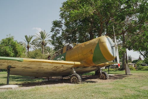 Yellow Trainer Aircraft on Green Grass Field