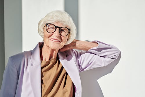 Free Smiling Elderly Woman in Purple Blazer with Black Framed Eyeglasses Stock Photo