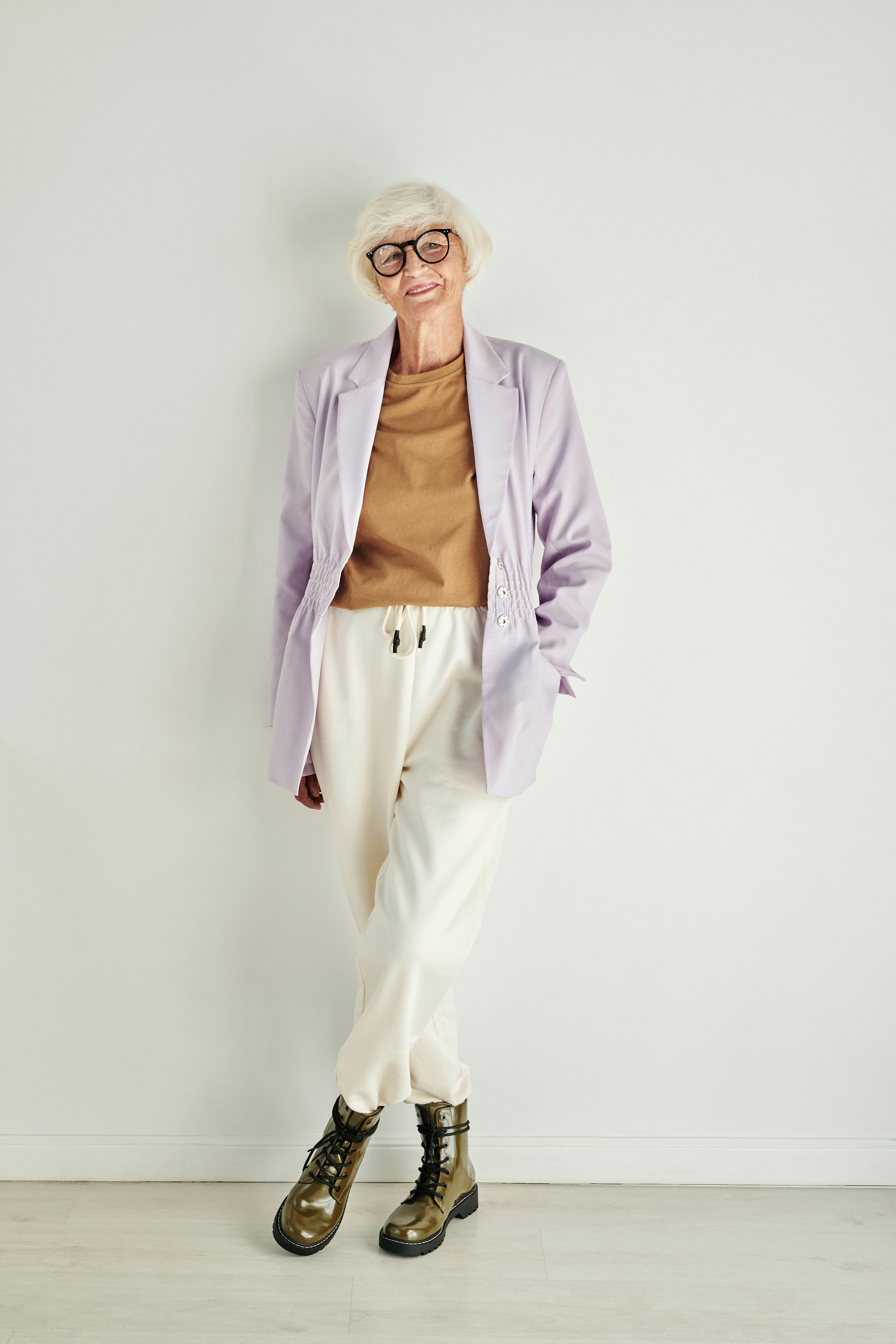 Stylish Elderly Woman in Black Leather Jacket and White Pants with