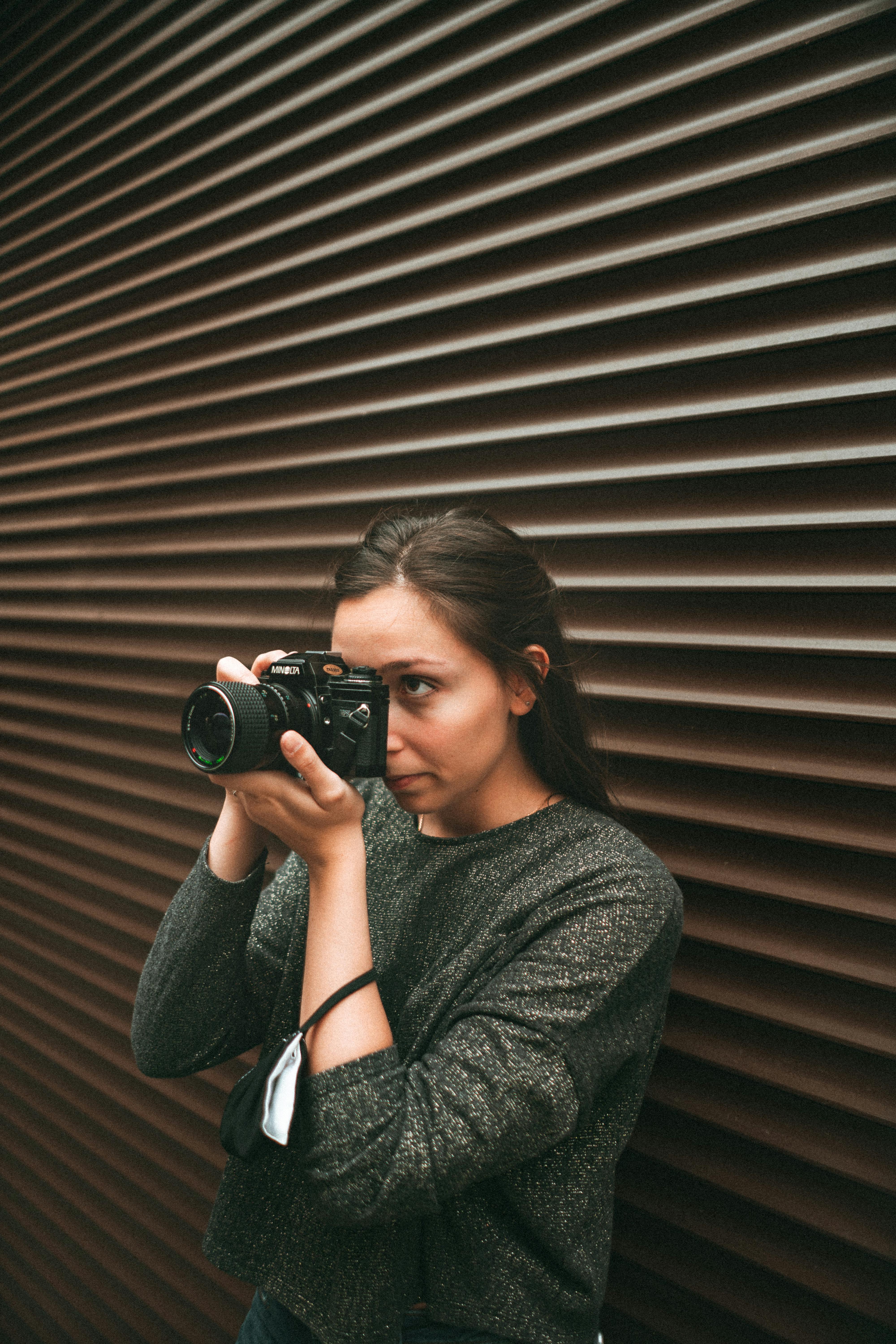 a woman taking a photo using a dslr camera