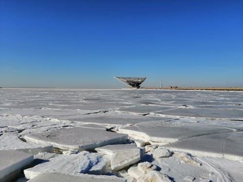 Ice Floes in Ocean Under Blue Sky