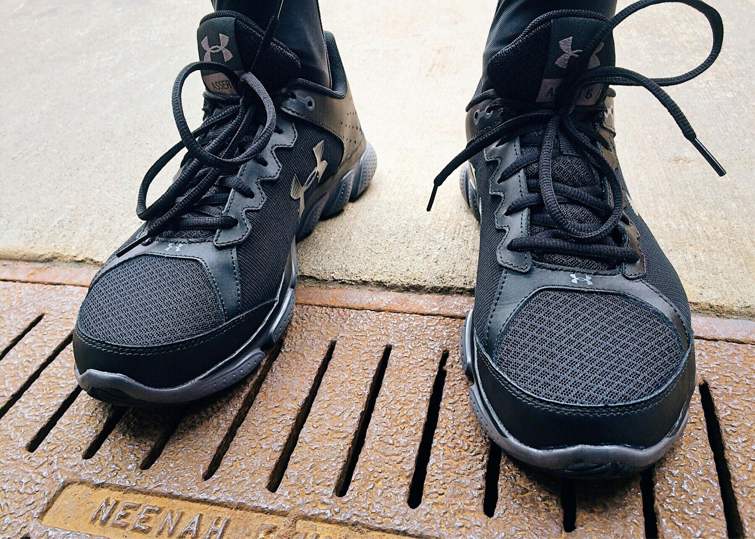 Golfer teeing off with a large grandstand in the background