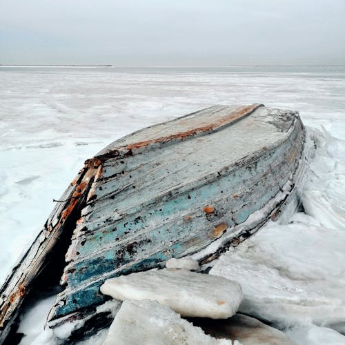 Free Broken Wooden Boat on Snow Stock Photo