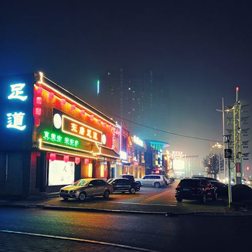 Cars Parked in Front of Store during Night Time