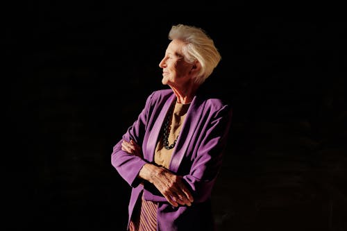 An Elderly Woman Wearing a Purple Blazer