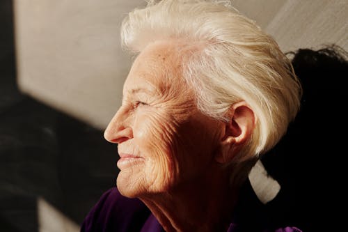 Elderly Woman in Purple Shirt Smiling