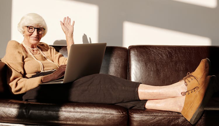 Elderly Woman Sitting On The Couch