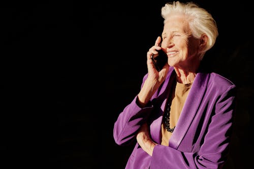 Woman in Purple Blazer Talking on the Phone