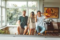 Man in Green Crew Neck T-shirt Sitting Beside Woman in Brown Button Up Shirt Beside Man in White Crew Neck T-shirt