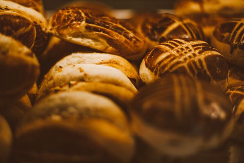 Free Delicious freshly baked artisan bread rolls stacked together, showcasing rich textures and golden brown crusts. Stock Photo