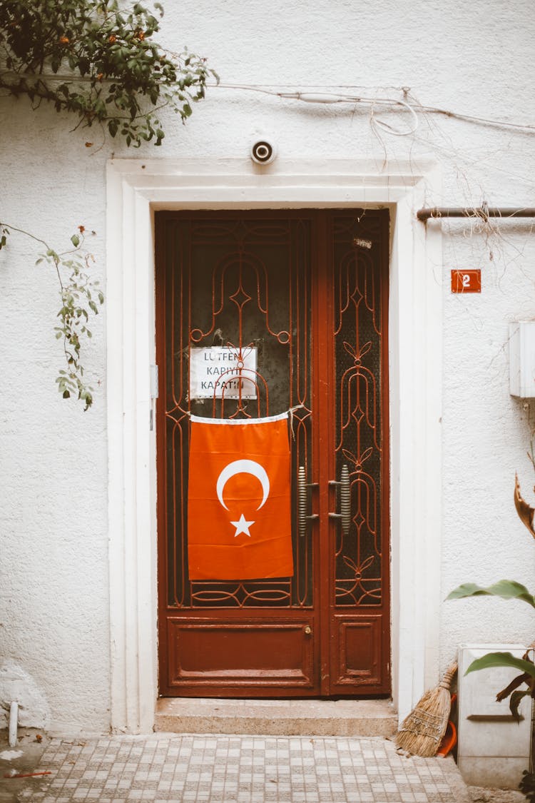 A Flag Of Turkey Hanging On A Door 