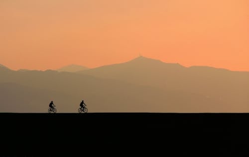 两个骑自行车的人的剪影照片