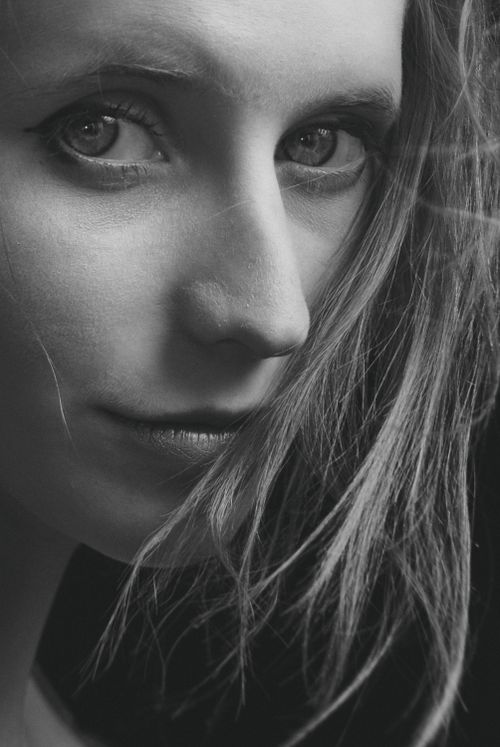 Free Striking grayscale close-up portrait of a woman's face, emphasizing her expressive eyes and natural beauty. Stock Photo