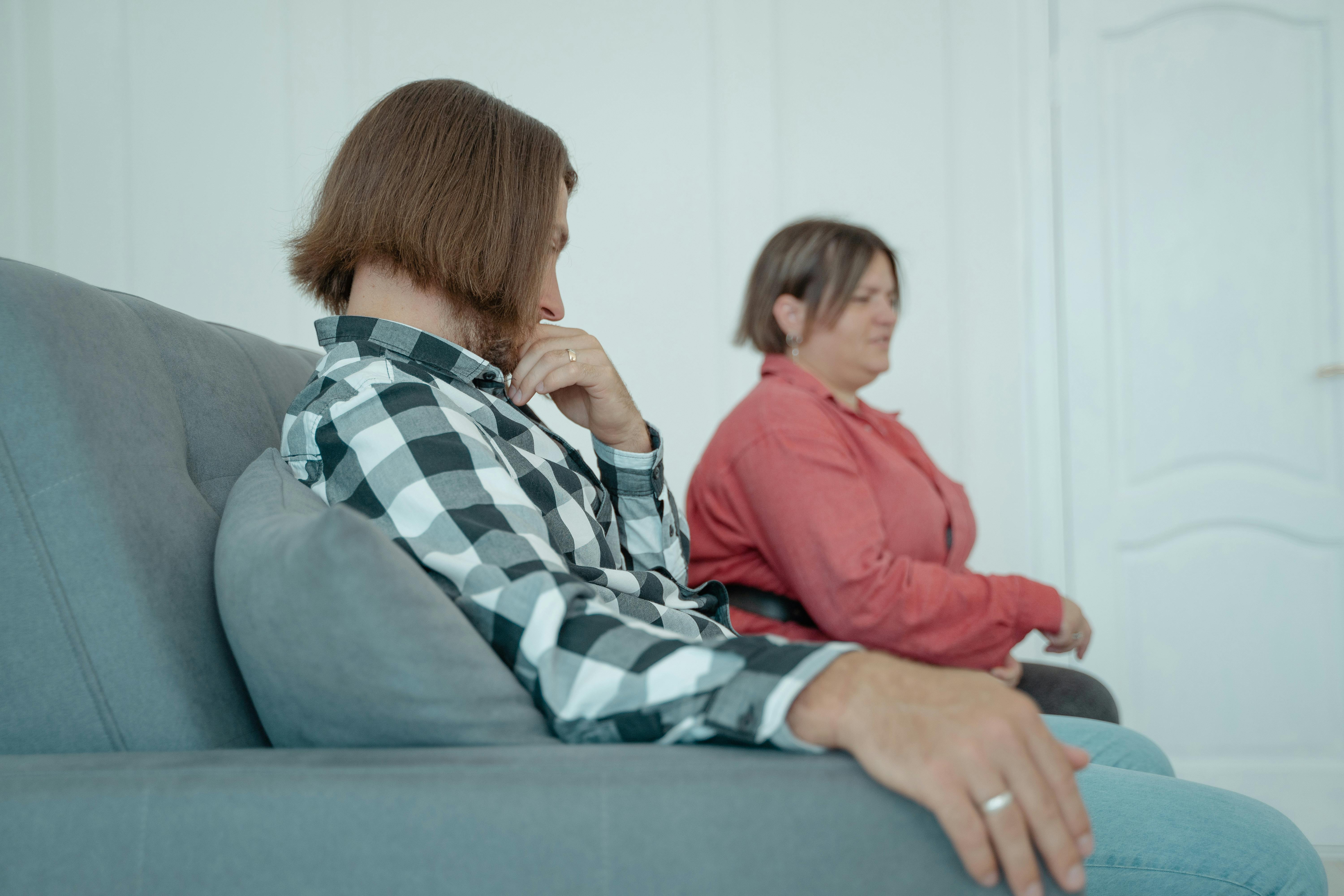 a man sitting beside a person on a couch