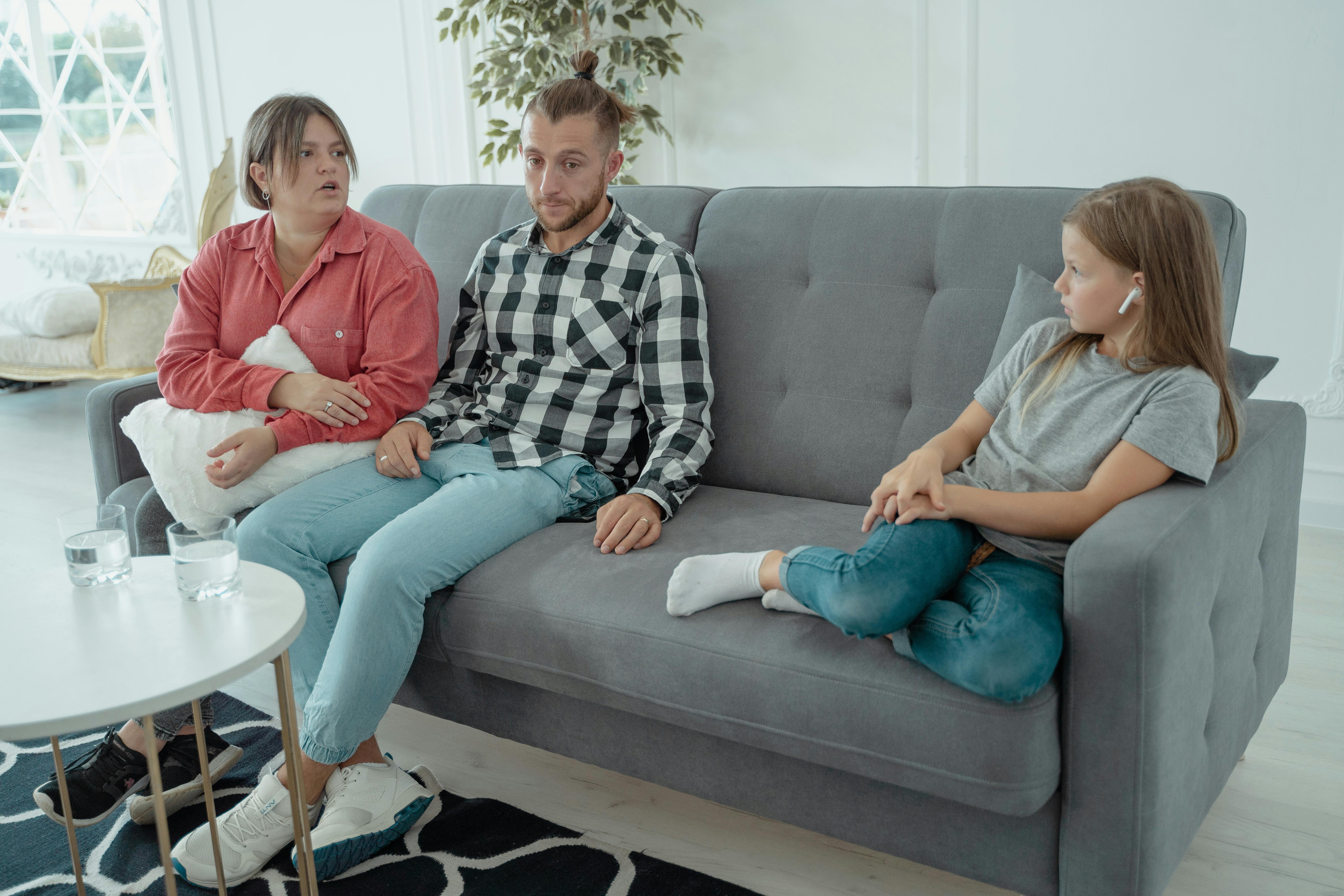 A Family Sitting On A Couch Free Stock Photo   Pexels Photo 5336933 