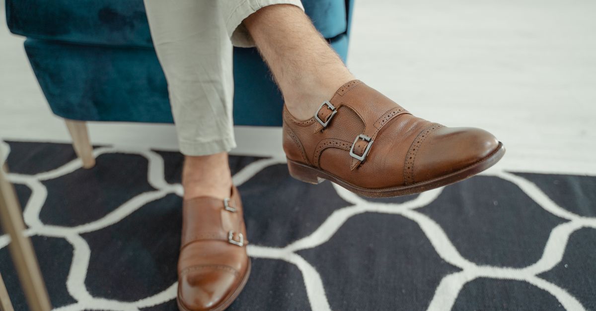Close-up of stylish brown leather shoes with double buckles, perfect for modern fashion and elegance.