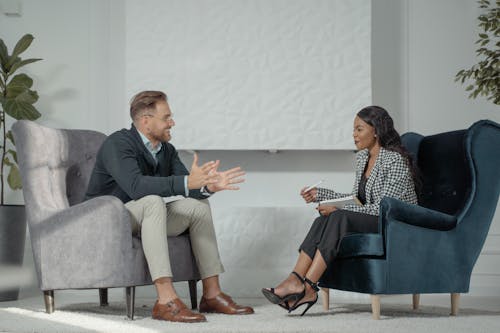 A Woman Interviewing a Man