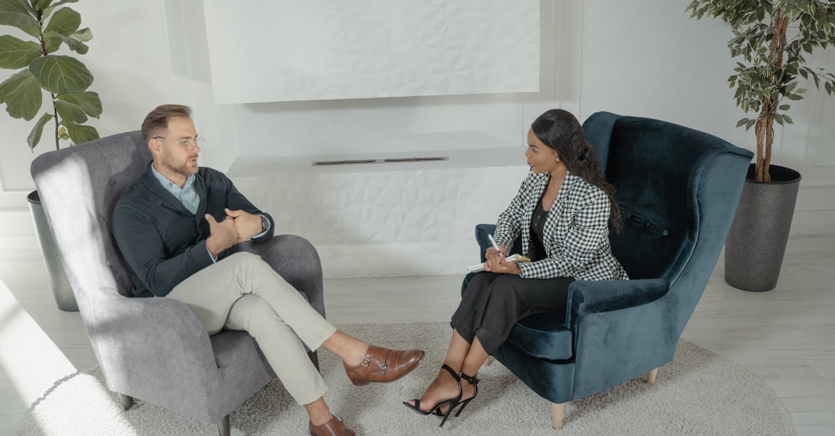 Two colleagues having a focused discussion by a whiteboard