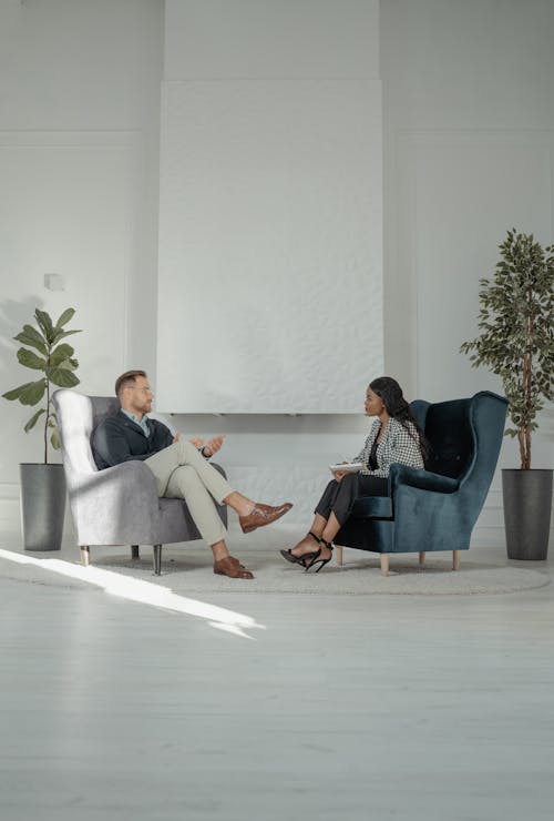 Man and Woman Sitting on Gray Sofa