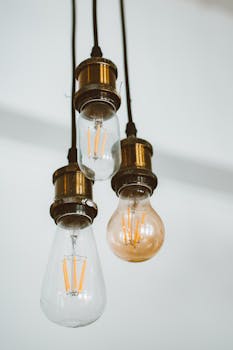 Close-up of vintage hanging light bulbs with visible filaments, providing warm illumination.