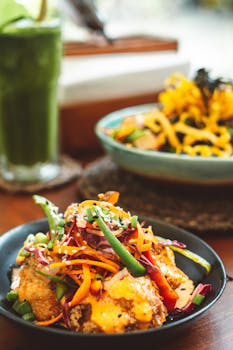 Colorful Asian fusion dish topped with fresh vegetables, ideal for a healthy meal.