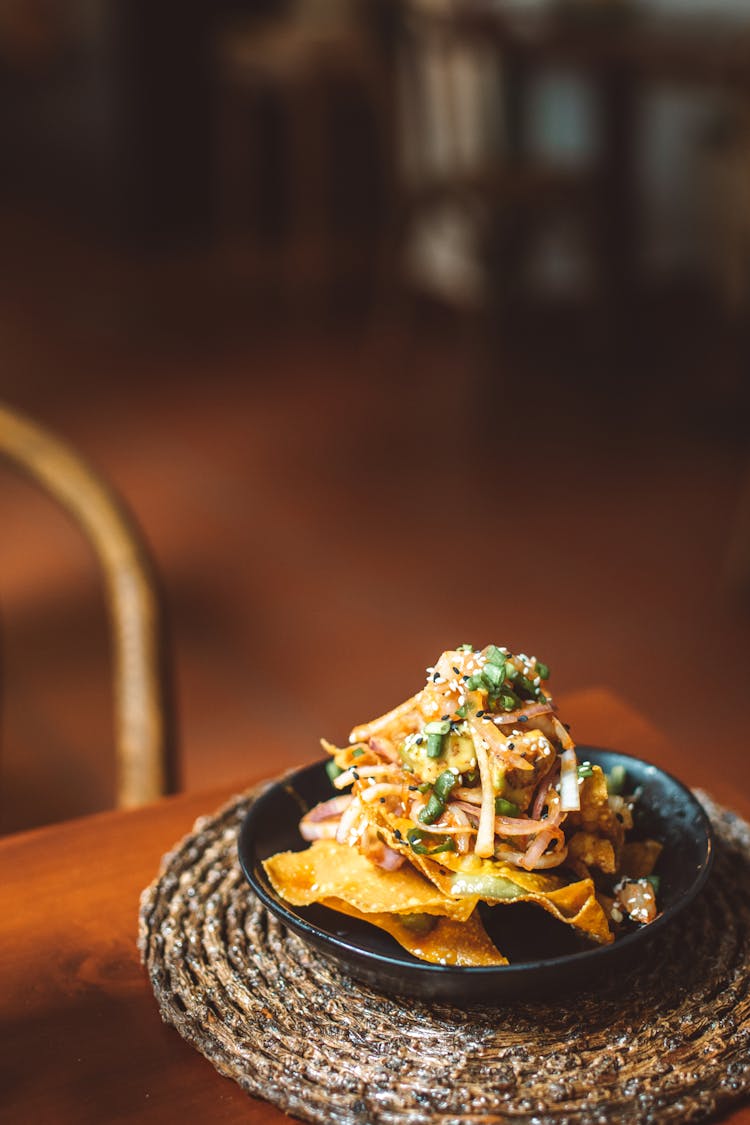 A Bowl Of Food On A Woven Placemat